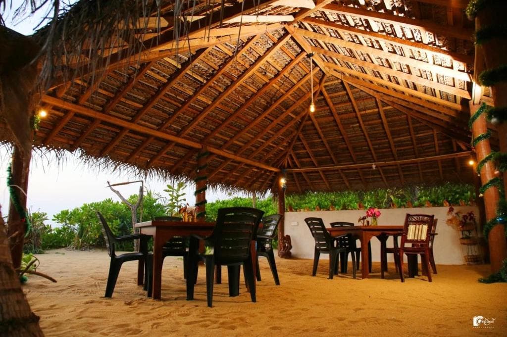 The open-air dining pavilion set on the sand