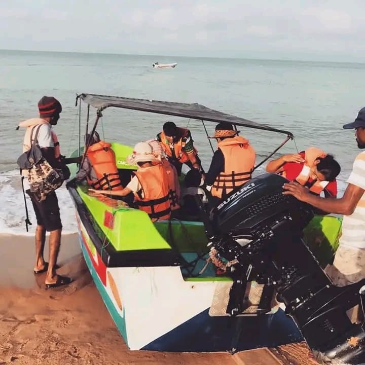 Guests preparing to leave the beach in a boat