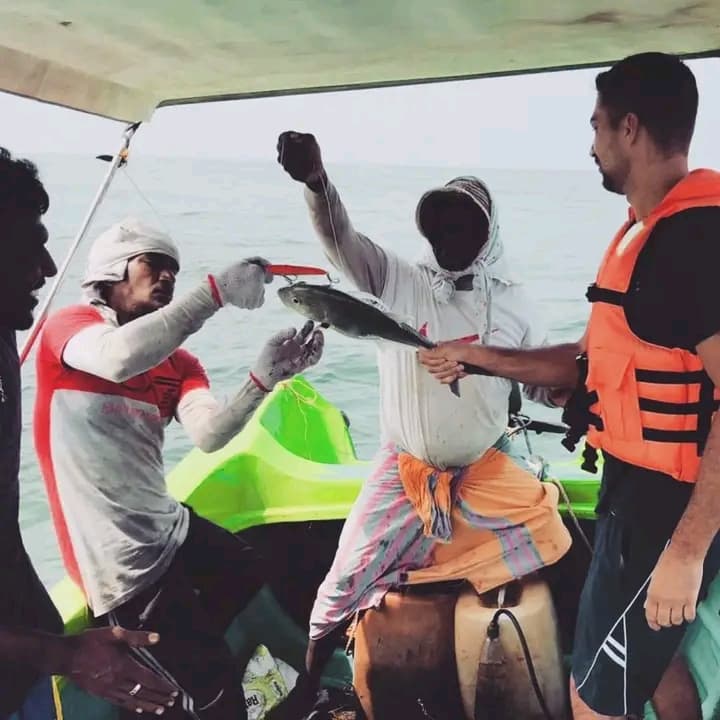 Guests celebrating a dolphin sighting on the boat
