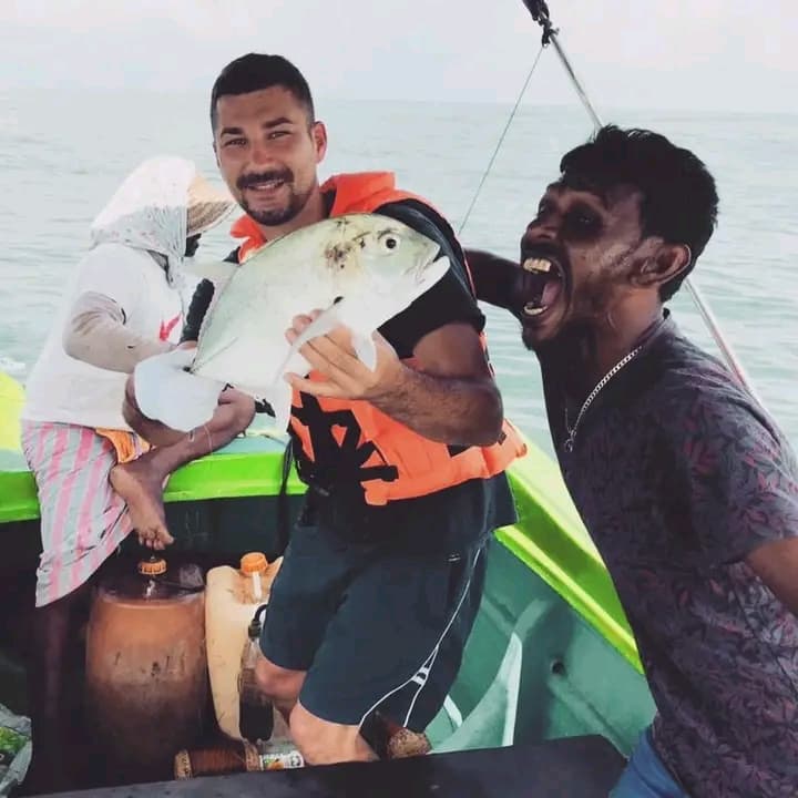 A guest and local guide smiling together on the boat