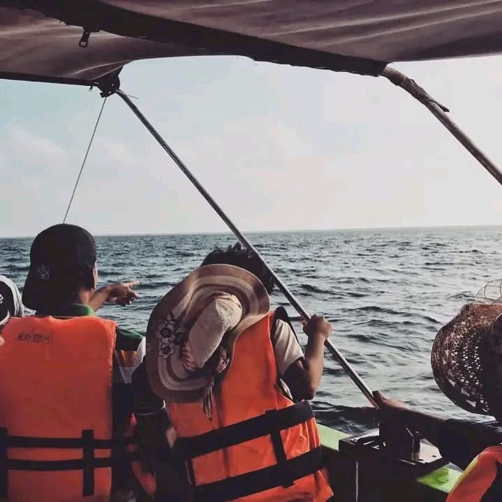 Guests seated inside the boat with the ocean ahead