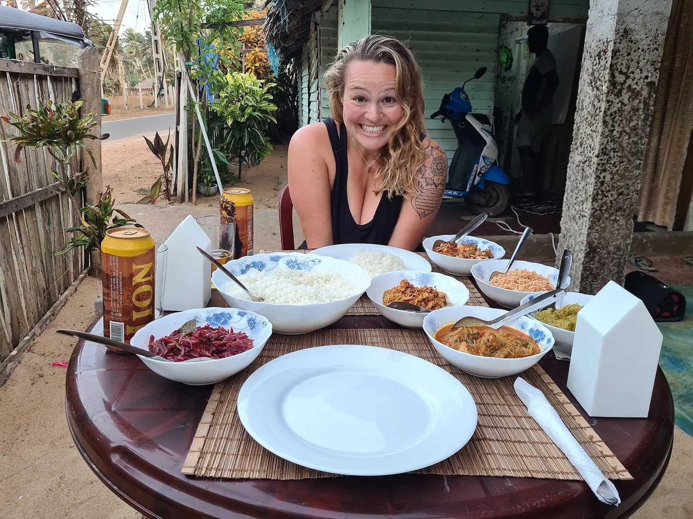 A guest at breakfast with the sea behind her
