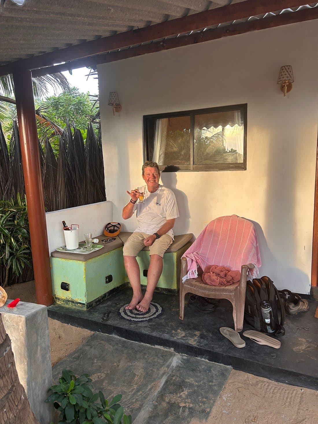 A guest relaxing on a shaded veranda