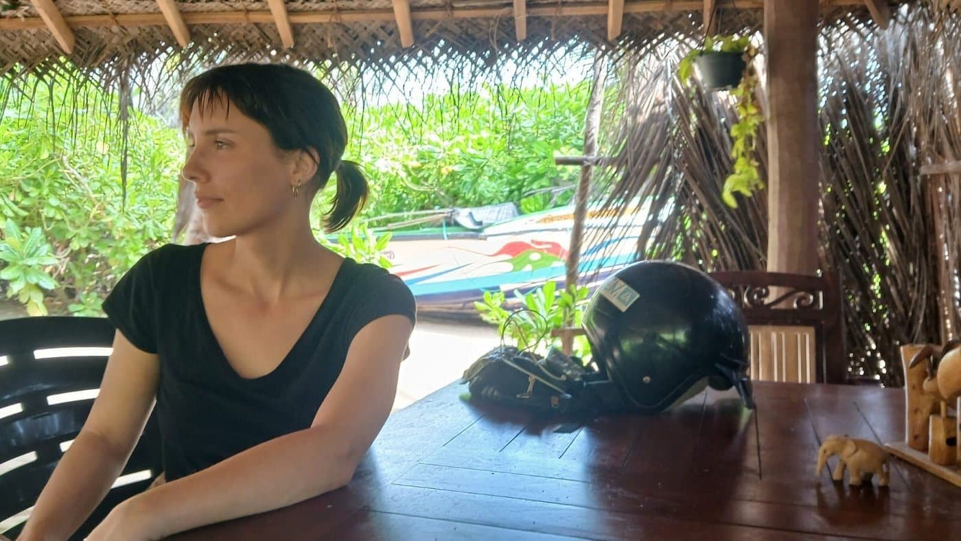 A guest at a table with a scooter helmet beside her
