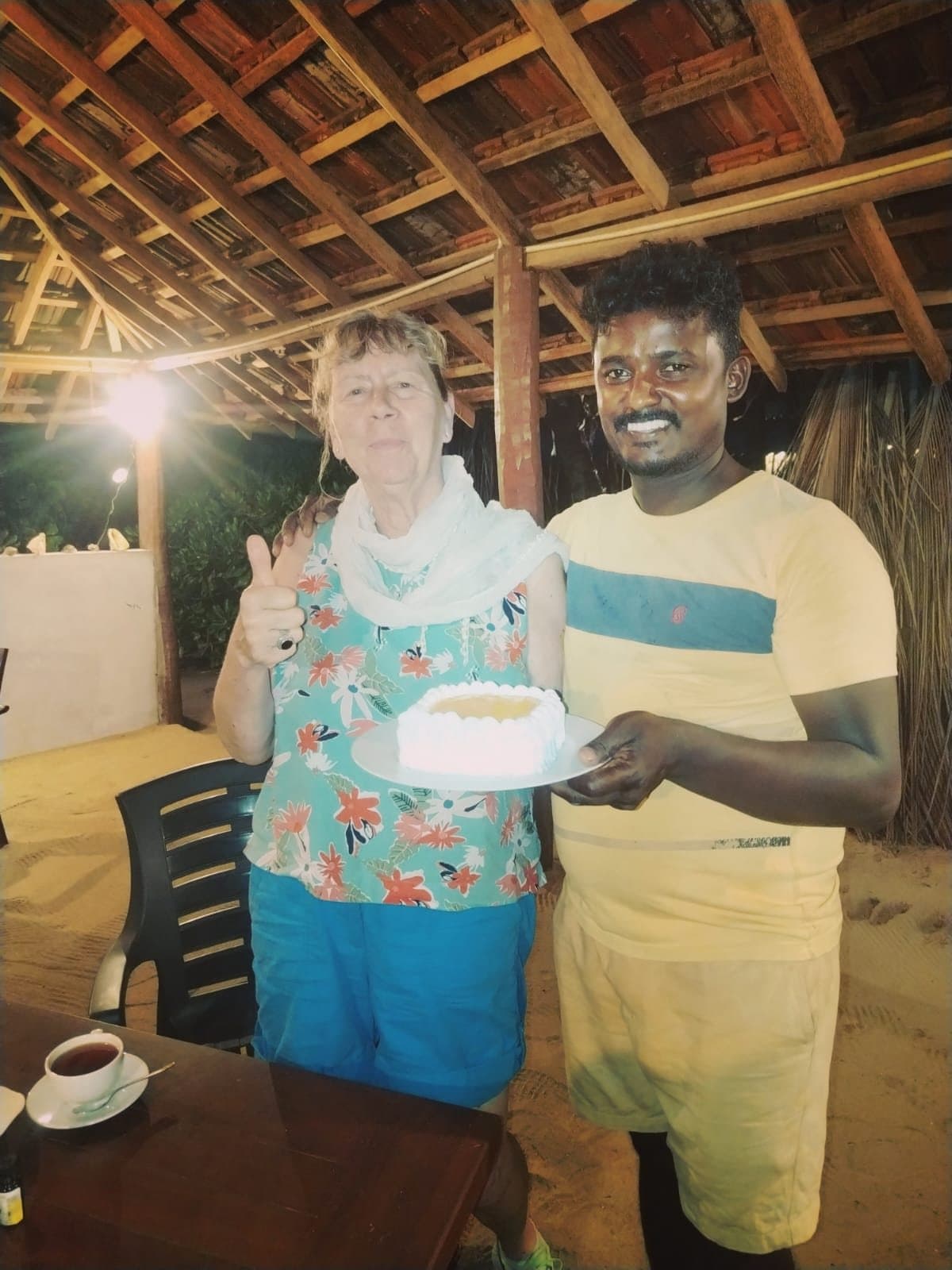 A guest holding a cake with Maduka