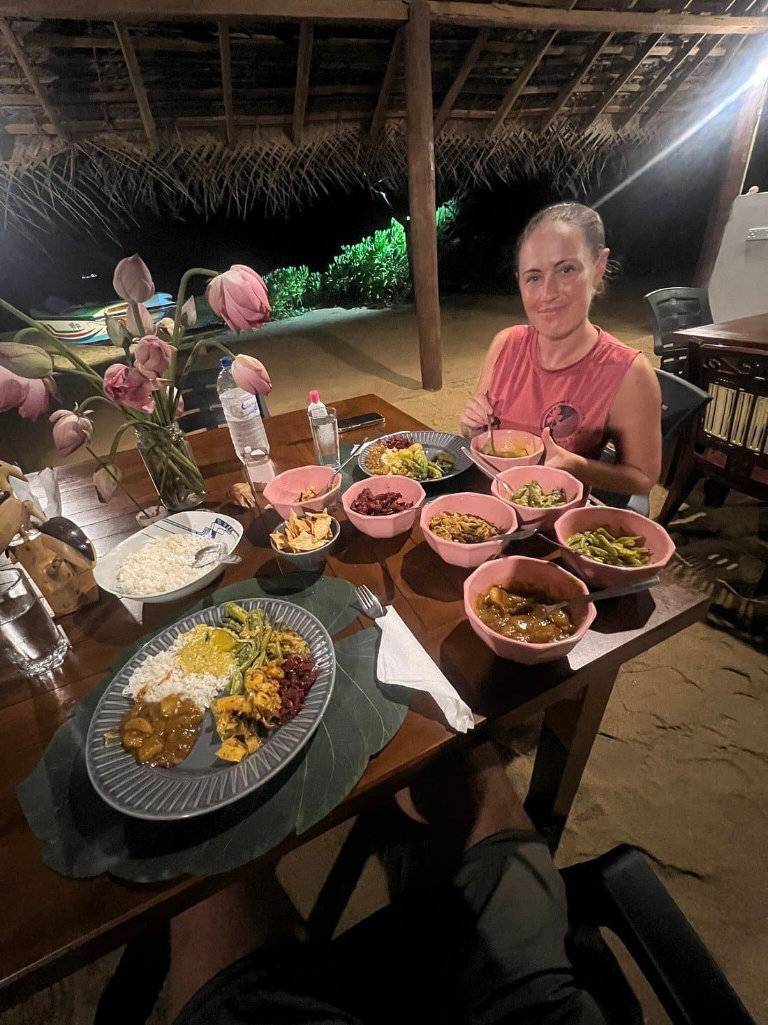 A guest at a table filled with Sri Lankan curries