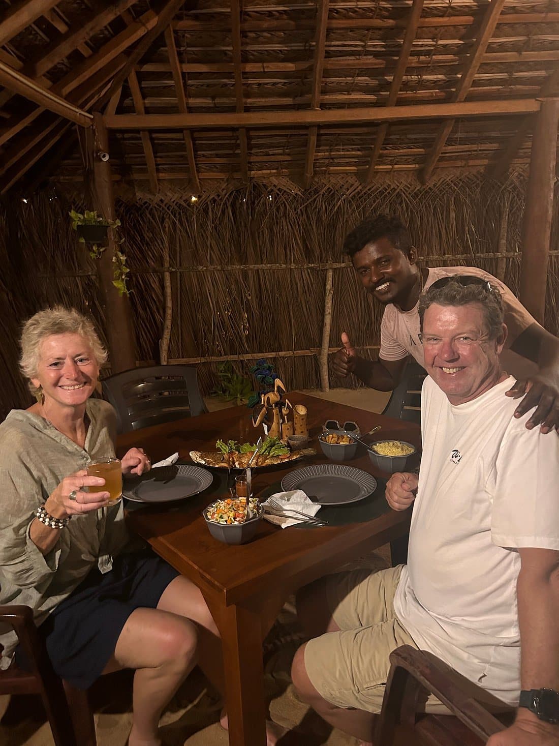 An older couple smiling over dinner