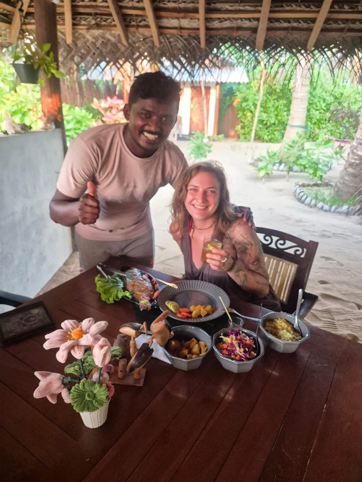 Maduka welcoming a guest at a candlelit table