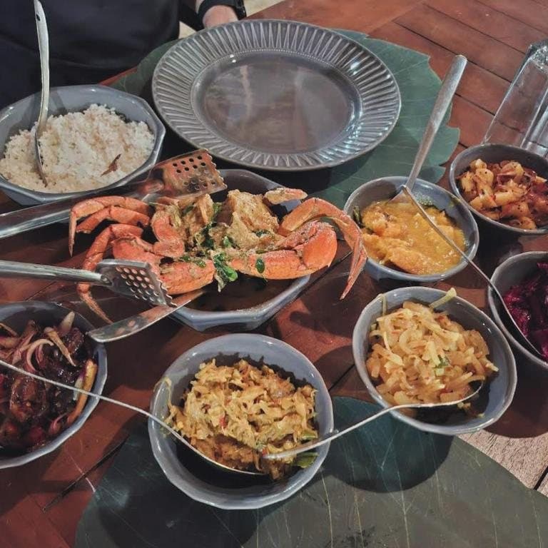 Puttalam Lagoon crab curry served with a table of Sri Lankan curries
