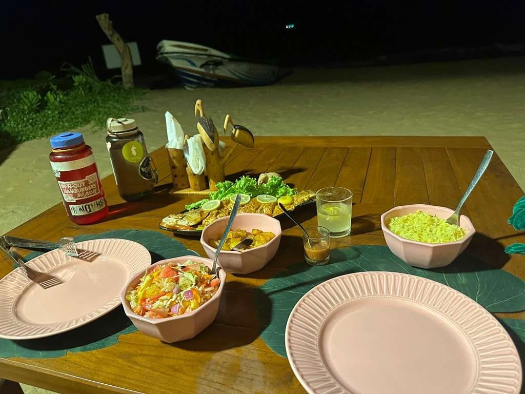 A generous dinner feast laid out on a table at night